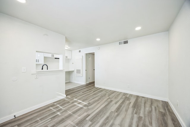 empty room with light hardwood / wood-style floors