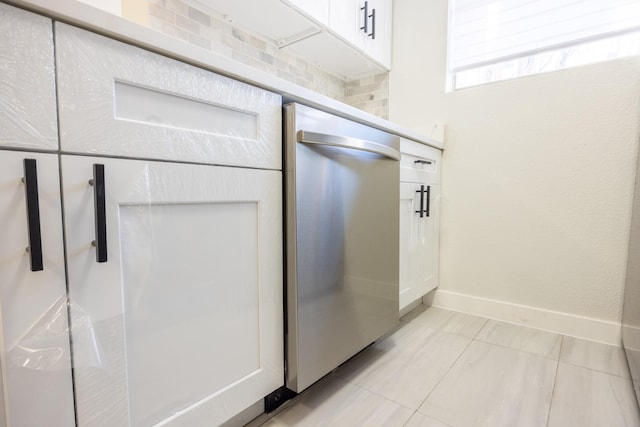 interior space with white cabinetry and stainless steel dishwasher