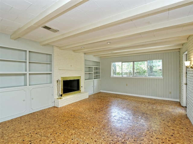 unfurnished living room featuring a fireplace, brick wall, and beam ceiling