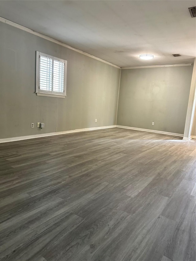 unfurnished room with crown molding and dark hardwood / wood-style flooring