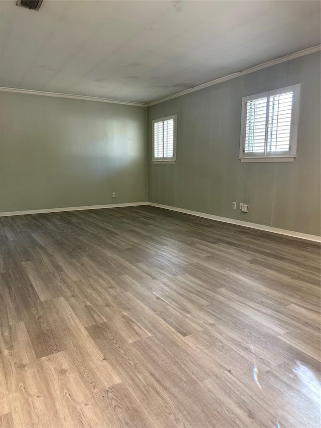 spare room with ornamental molding and plenty of natural light