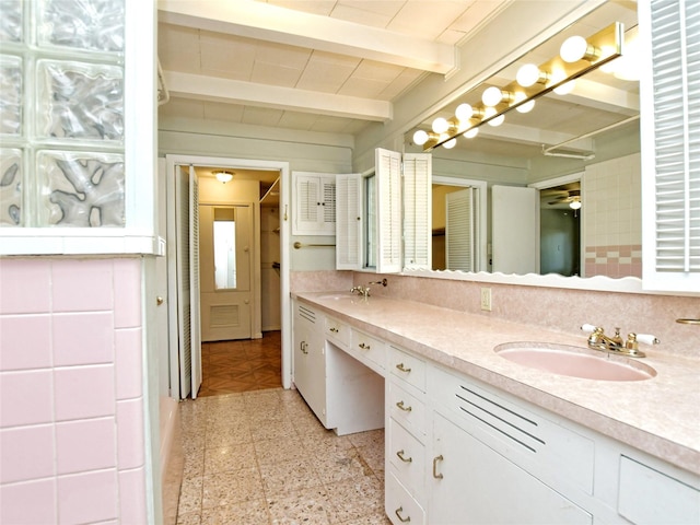 bathroom featuring vanity, ceiling fan, and beam ceiling