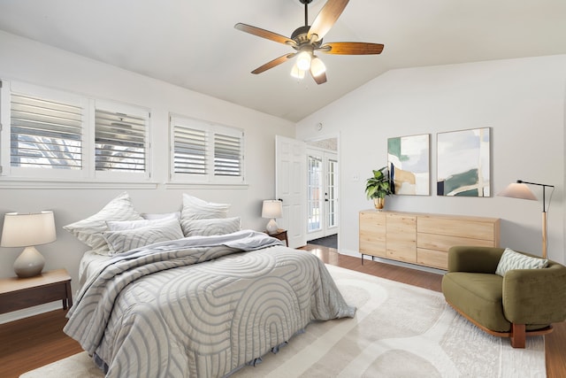 bedroom featuring wood-type flooring, vaulted ceiling, french doors, and ceiling fan