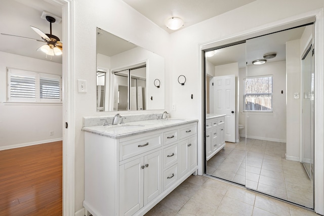 bathroom with ceiling fan, vanity, toilet, and tile patterned flooring