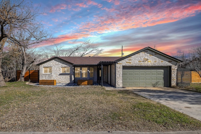 ranch-style house with a garage and a lawn