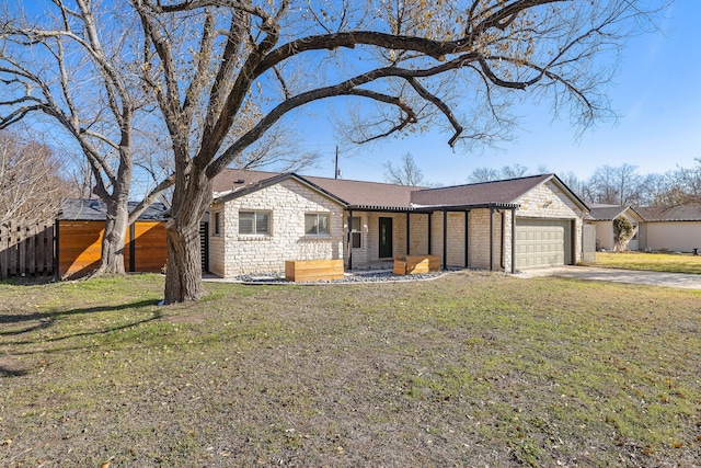 ranch-style home featuring a garage and a front lawn