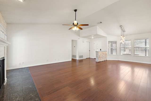 unfurnished living room featuring dark hardwood / wood-style flooring, ceiling fan with notable chandelier, and vaulted ceiling