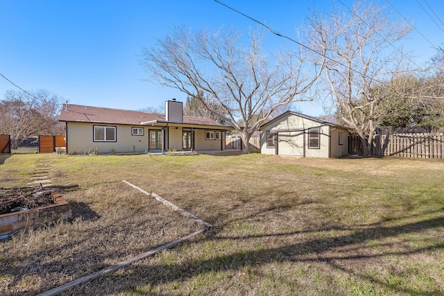 rear view of house featuring a lawn