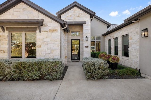 view of exterior entry featuring stone siding