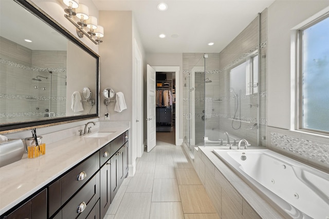 bathroom featuring vanity and shower with separate bathtub