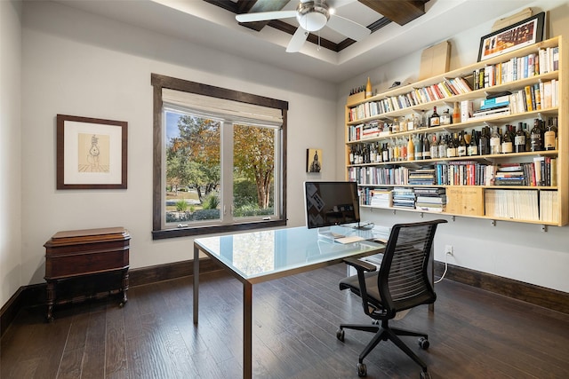 home office with beamed ceiling, ceiling fan, and dark hardwood / wood-style floors