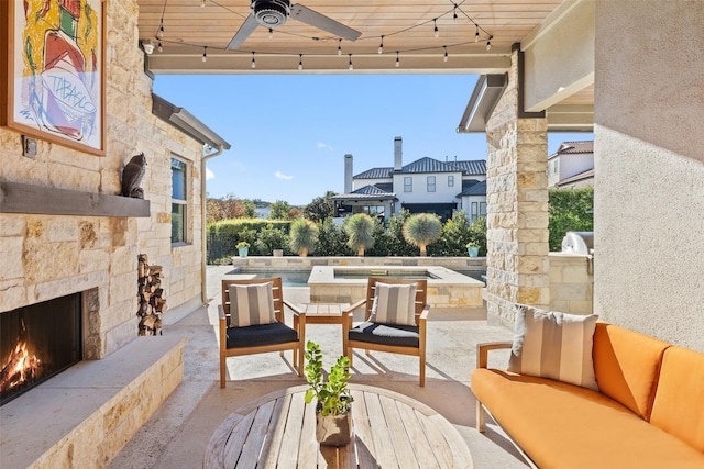 view of patio / terrace with an outdoor living space with a fireplace and ceiling fan