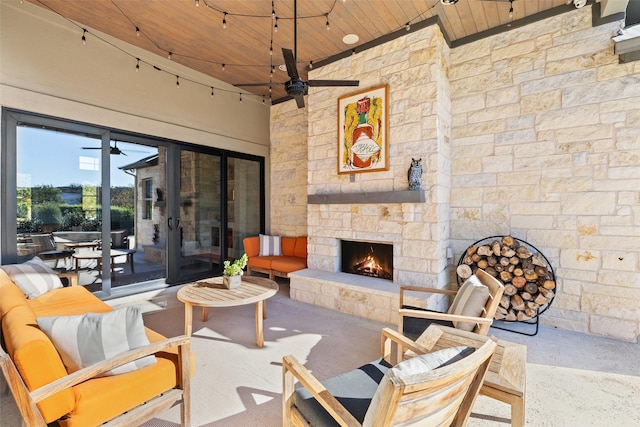 view of patio / terrace with ceiling fan and an outdoor stone fireplace