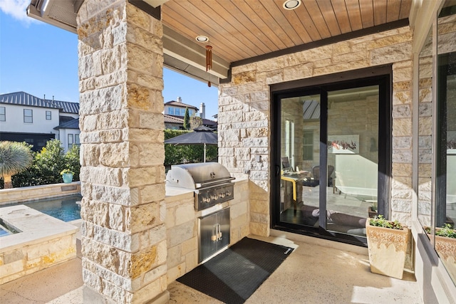 view of patio with area for grilling and exterior kitchen