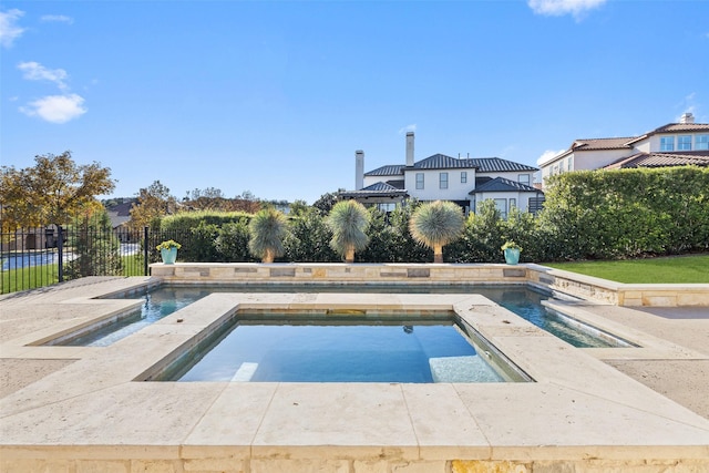 view of swimming pool featuring an in ground hot tub