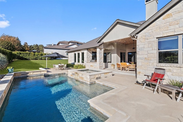 view of swimming pool with an in ground hot tub, a yard, and a patio area