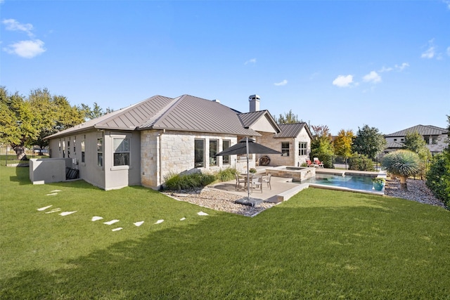 rear view of property with a patio area and a lawn