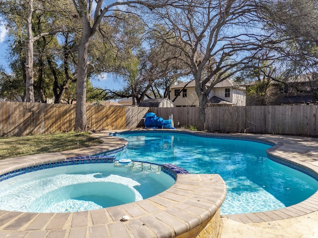 view of pool with an in ground hot tub