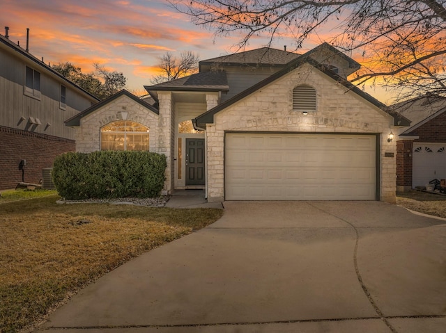 view of front of home featuring cooling unit and a garage