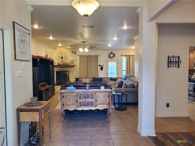 living room featuring a fireplace, tile patterned floors, and ceiling fan