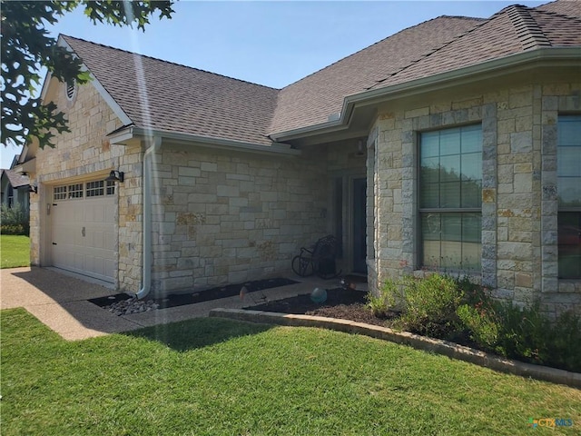 view of home's exterior with a garage and a yard