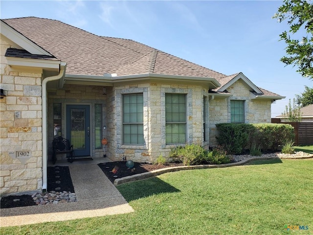 entrance to property featuring a yard