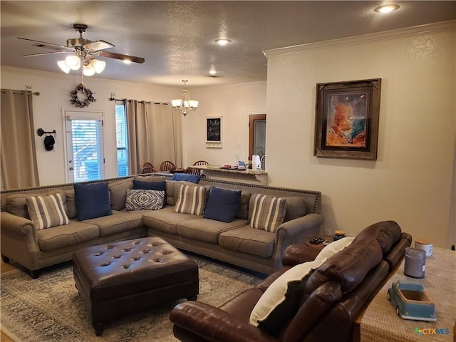 living room featuring ornamental molding, ceiling fan with notable chandelier, and a textured ceiling