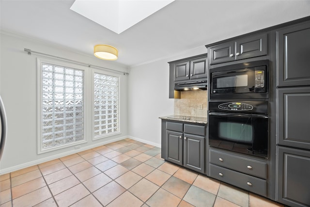 kitchen with light tile patterned floors, a skylight, tasteful backsplash, ornamental molding, and black appliances