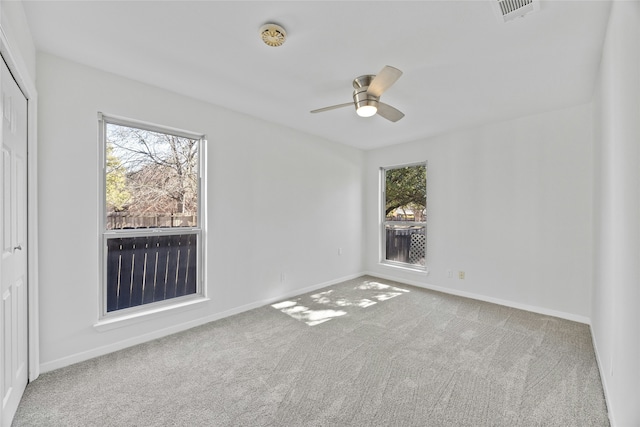 spare room with carpet flooring and ceiling fan