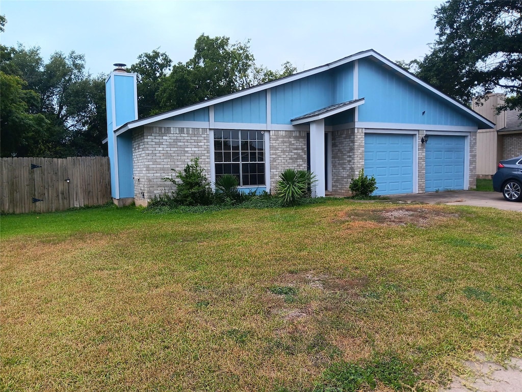 ranch-style home with a garage and a front yard