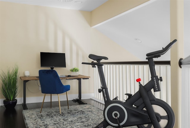 workout room with lofted ceiling and wood-type flooring