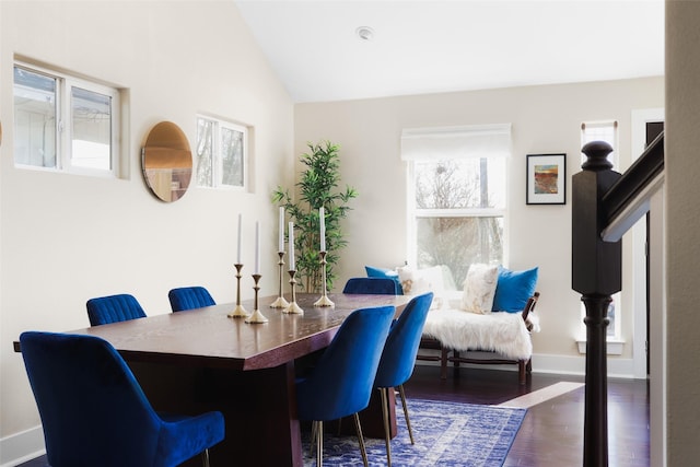 dining area with lofted ceiling and dark wood-type flooring