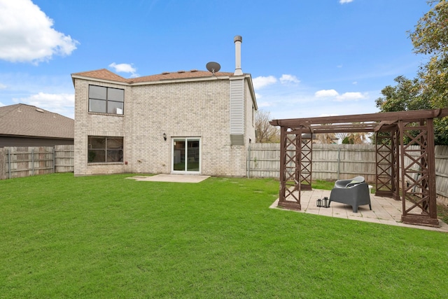 back of house featuring a pergola, a patio area, and a lawn