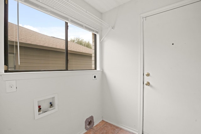 clothes washing area with hookup for a washing machine, hookup for an electric dryer, and light tile patterned floors