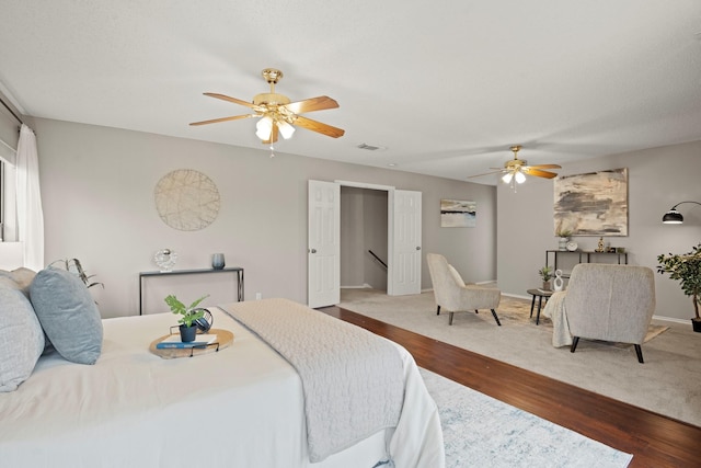 bedroom with hardwood / wood-style flooring and ceiling fan