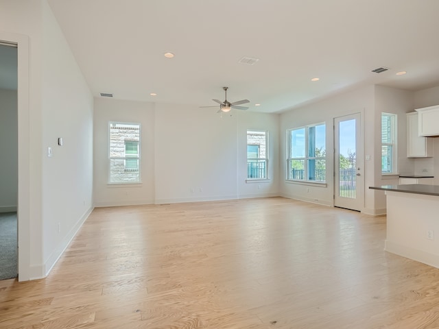 unfurnished living room with light hardwood / wood-style flooring and ceiling fan