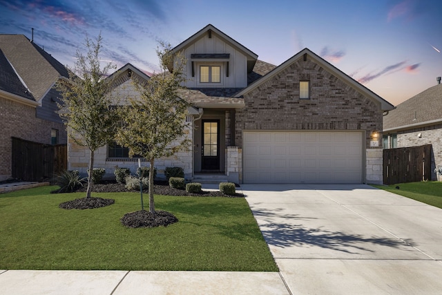 view of front facade featuring a garage and a yard