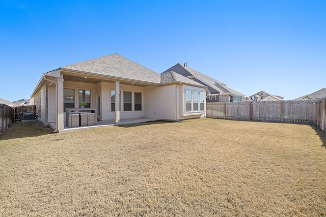 back of house with a yard and a patio area