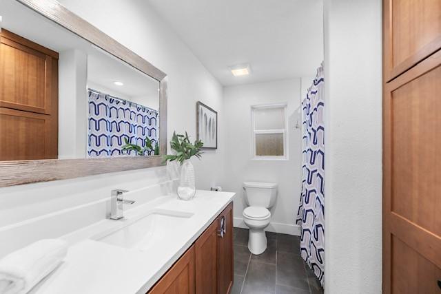 bathroom with tile patterned floors, vanity, and toilet