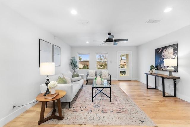 living room featuring ceiling fan and light wood-type flooring