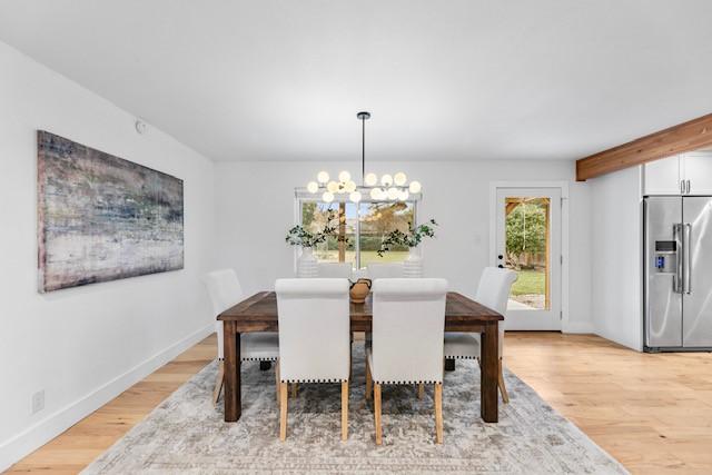 dining space featuring a notable chandelier and light hardwood / wood-style flooring