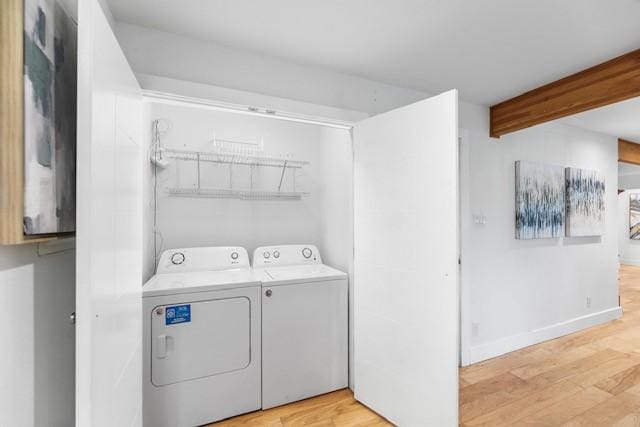 washroom with independent washer and dryer and light hardwood / wood-style floors