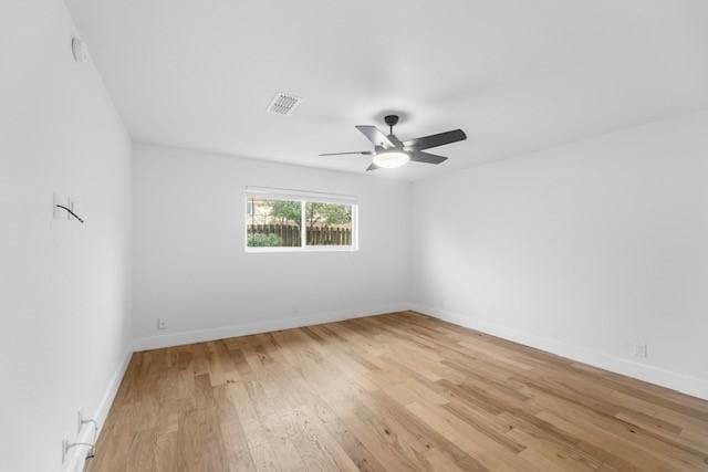 unfurnished room with ceiling fan and light wood-type flooring