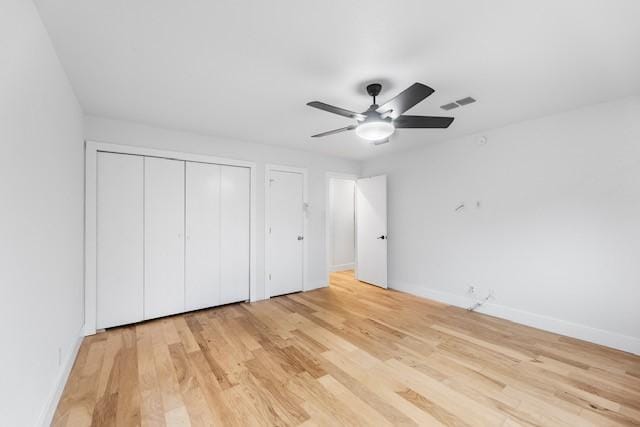 unfurnished bedroom with ceiling fan and light hardwood / wood-style floors