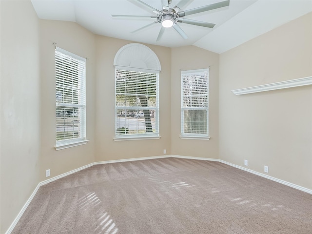 carpeted empty room with vaulted ceiling and ceiling fan