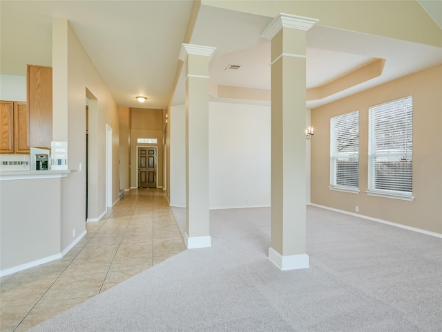 interior space with light tile patterned floors and decorative columns