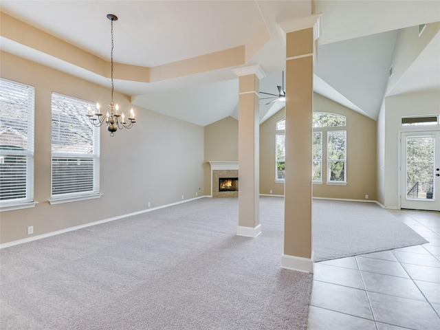 unfurnished living room featuring light carpet, ceiling fan with notable chandelier, and a fireplace