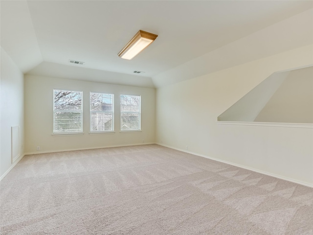 bonus room featuring light carpet and lofted ceiling