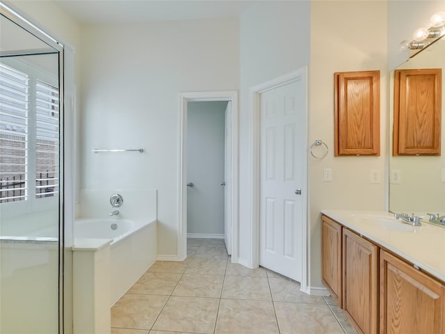 bathroom with vanity, a bath, and tile patterned floors