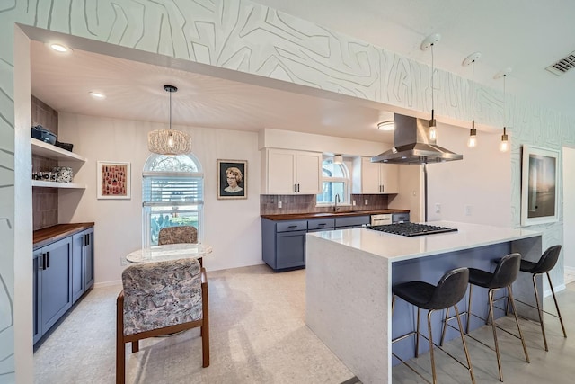 kitchen with blue cabinets, white cabinetry, island exhaust hood, and pendant lighting